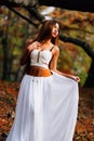 Fantastic young woman. beautiful fantasy girl fairy with white long dress in windy autumn park Royalty Free Stock Photo