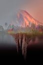 Erupting Volcano Behind Suspended Wildflower Island in Surreal Landscape Royalty Free Stock Photo