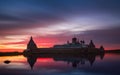 Fantastically beautiful pink sunset on on the Holy Lake with a view of the Solovetsky Spaso-Preobrazhensky Monastery.Russia. Royalty Free Stock Photo