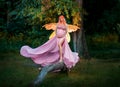 Fantasy art portrait red-haired woman fairy sits on log, creative design costume butterfly wings bright glow. Elf girl Royalty Free Stock Photo