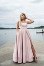 fantasy charming woman in elegant ping evening dress relaxing near lake Royalty Free Stock Photo