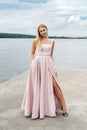 fantasy charming woman in elegant ping evening dress relaxing near lake Royalty Free Stock Photo