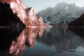 Fantasy colors of the Dolomite mountains in the Braies lake towards sunset