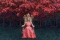 Fantasy concept of queen sitting on the throne in magical forest