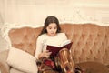 Fantasy genre. Bookstore concept. Childhood literature. Winter wonderland. Adorable girl reading book christmas eve Royalty Free Stock Photo