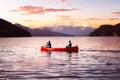 Fantasy Image Composite of Adventurous People on a Wooden Red Canoe