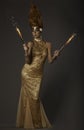 Fantasy image of flame-throwing woman in gold couture Royalty Free Stock Photo