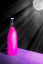 Fantasy magic love potion. Neon pink elixir in moonlit drink bottle. Royalty Free Stock Photo