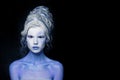 Fantasy makeup. Nice model woman with white and blue skin and creative hairstyle on black background