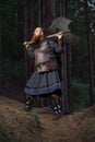 Fantasy medieval red-haired gnome warrior with beard with huge ax halberd in forest