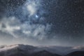 Fantasy night landscape, Beautiful mountains landscape, huge clouds descended to the mountain tops under bright starry sky.