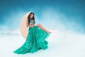Fantasy portrait of a beautiful tanned brunette girl in a turquoise Oriental dress and jewelry Royalty Free Stock Photo