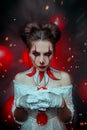 Fantasy portrait evil woman clown, Creative drawing professional halloween holiday makeup body art. Red white black