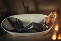 Fantasy real mermaid woman lies, white bathtub. captive chains on hands, prisoner sad face. Fabulous girl sea nymph Royalty Free Stock Photo