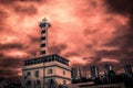 Fantasy scene of lighthouse with red sky.