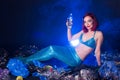 Fantasy stupid mermaid in deep ocean. Plastic trash and bottles pollution in ocean. Ecocatastrophe, garbage and plastic