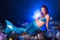 Fantasy stupid mermaid in deep ocean. Plastic trash and bottles pollution in ocean. Ecocatastrophe, garbage and plastic