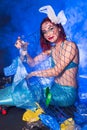 Fantasy stupid mermaid in deep ocean. Plastic trash and bottles pollution in ocean. Ecocatastrophe, garbage and plastic