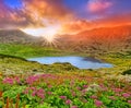 Fantasy sunset landscape with mountain and lake.