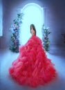 Fantasy woman princess in skirt lush pink neon bright color dress ball gown back rear view. Queen girl fashion model Royalty Free Stock Photo