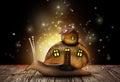 Fantasy world. Magic snail with its shell house moving on wooden surface surrounded by fairy lights Royalty Free Stock Photo