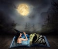 Fantasy world. Open book of fairytales with witch and black crow on pages