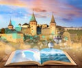 Fantasy worlds in fairytales. Book, hot air balloons and enchanted castle on background