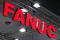A Fanuc company logo on the wall. Fanuc provides automation products and services such as robotics and computer numerical control Royalty Free Stock Photo