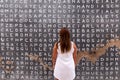 Fanzara CastellÃÂ³n, Spain - September 20, 2020: A woman in front of a word search that is part of a work of urban art made by A