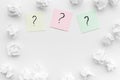 FAQ concept. Question mark on sticky notes near crumpled paper on white background top view copy space Royalty Free Stock Photo