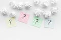 FAQ concept. Question mark on sticky notes near crumpled paper on white background top view copy space