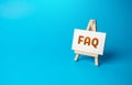 FAQ on an easel stand. Answers to frequently asked questions. Royalty Free Stock Photo