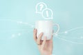 FAQ frequently asked questions concept. Girl hand hold morning coffee cup with FAQ question answer sign Icon on blue background.