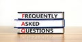 FAQ frequently asked questions symbol. Concept words `FAQ frequently asked questions` on books on a beautiful wooden table, whit Royalty Free Stock Photo