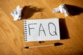 Faq, frequently asked questions text on notebook