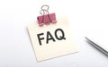 FAQ text on the sticker with pen on the white background Royalty Free Stock Photo