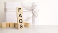 faqs text on a wooden cubes on a white paper background