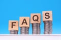 faqs - text on wood cubes stack with coins