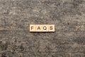 faqs word written on wood block. faqs text on table, concept