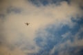 Far away of flying drone on cloudy blue sky and maybe it will out of control. Professional camera drone flying in blue sky and Royalty Free Stock Photo