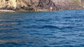 Sailing fast alongshore and zooming in to show the stony cliff. Cliffside.