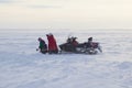 Far North, Yamal Peninsula, a snowmobile broke, a woman with a child walks along the snow tundra Royalty Free Stock Photo