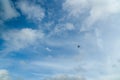 Far view of silhouette four engine propeller airplane on blue sky