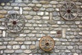 Far west wagon wheel on stone wall