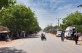 FARAFENNI, GAMBIA - CIRCA MARCH, 2017: motorcycle turns on main street at noon
