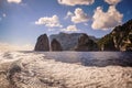 The Faraglioni of Capri seen from the sea, behind the wake of a boat Royalty Free Stock Photo