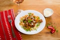 Farfalle with meat, mushrooms, olives and basil on a classic wood