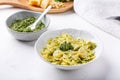 Farfalle pasta in  basil pesto sauce in white plate on white table Royalty Free Stock Photo