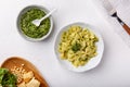 Farfalle pasta in  basil pesto sauce in white plate on white table Royalty Free Stock Photo