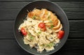 Farfalle pasta in cream sauce with chicken and tomatoes. Chicken italian bow tie pasta. Homemade italian food concept. Royalty Free Stock Photo